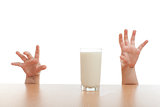 two hands and glass of milk
