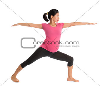 Asian pregnant yoga class.