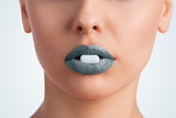 pill between female lips 