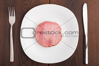 Slice of ham on white plate