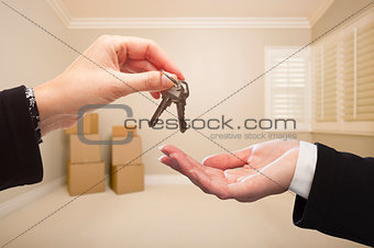 Woman Handing Over the House Keys Inside Empty Tan Room