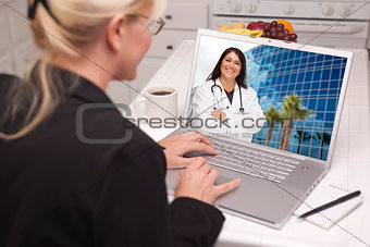 Woman In Kitchen Using Laptop - Online with Nurse or Doctor