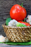Tomatoes, cucumbers and garlic in a basket