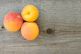 Ripe Tasty Apricots on the Old Wooden Table
