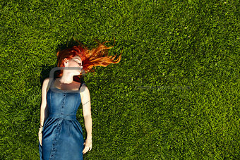 red haired girl on the grass