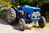 old blue tractor on the road