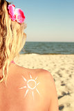  sun cream on the female back on the beach