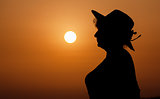 Silhouette woman portrait against orange sunset