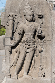 Female deity on relief carving in buddhist temple, Indonesia