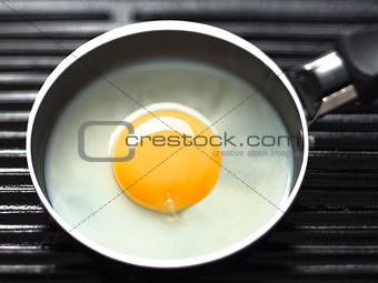 frying egg on a grill