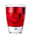 Red drink with ice cubes in a glass