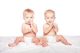Cute twins babies with spoons