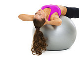 Fitness young woman making exercise on fitness ball