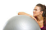 Fitness young woman with fitness ball looking on copy space