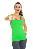 Happy fitness young woman showing thumbs up