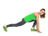 Smiling fitness young woman stretching