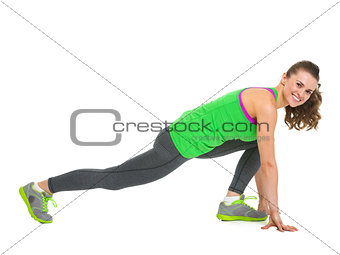 Smiling fitness young woman stretching