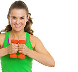 Portrait of smiling fitness young woman with dumbbells