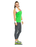 Smiling fitness young woman standing on scales