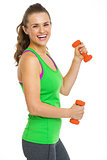 Portrait of smiling fitness young woman with dumbbells