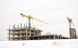 building construction industry cranes winter snow 