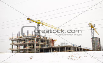 building construction industry cranes winter snow 