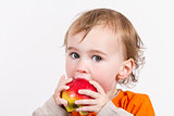 young child eating red apple