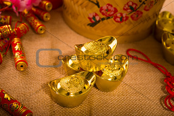 Chinese new year with decoration, large gold ingot and mandarin 
