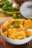 famous singapore curry noodle with ingredients as background