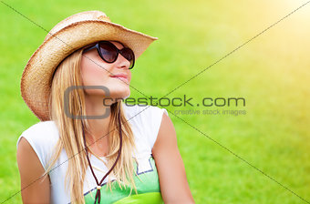 Cute female on green field
