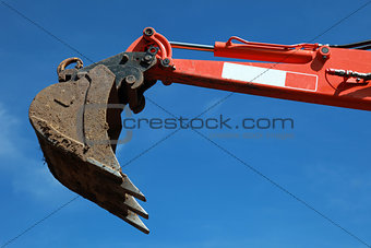Raised scoop of an earth mover