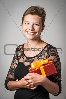Happy girl with evening dress and present