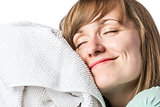 Pretty girl cuddling in a towel