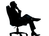 one business man sitting in armchair relaxing thinking silhouett
