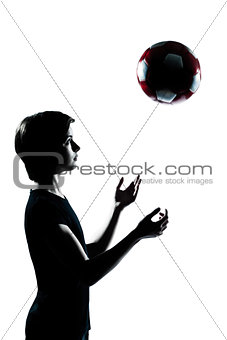 one young teenager boy  girl silhouette tossing soccer football