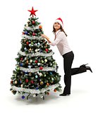 Woman standing near decorated Christmas tree