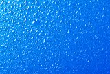 Blue background texture covered with water drops