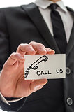 Closeup of a business man handing card with Call us message