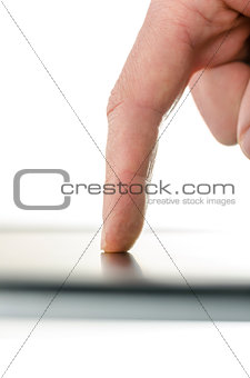 Side view of male finger writing a message on a smart phone