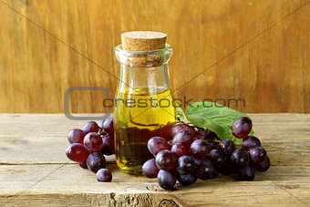 bottle with grape seed oil on a wooden table