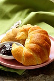 Fresh French croissant with jam for breakfast