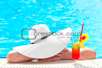 girl in the pool with a cocktail