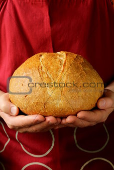 loaf of homemade bread in the chef hands