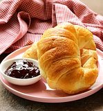 Fresh French croissant with jam for breakfast
