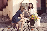 couple of fashion girls with bicycle 