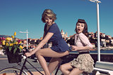 funny vintage girls on bicycle near the sea