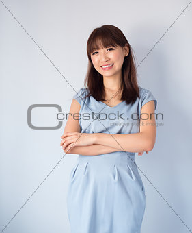 Asian woman isolated on blue background.