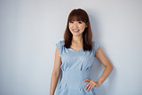 Cute Asian woman isolated on blue background.