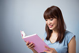 Asian woman reading a book 