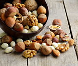 Mix nuts (almonds, hazelnuts, walnuts) on a wooden table